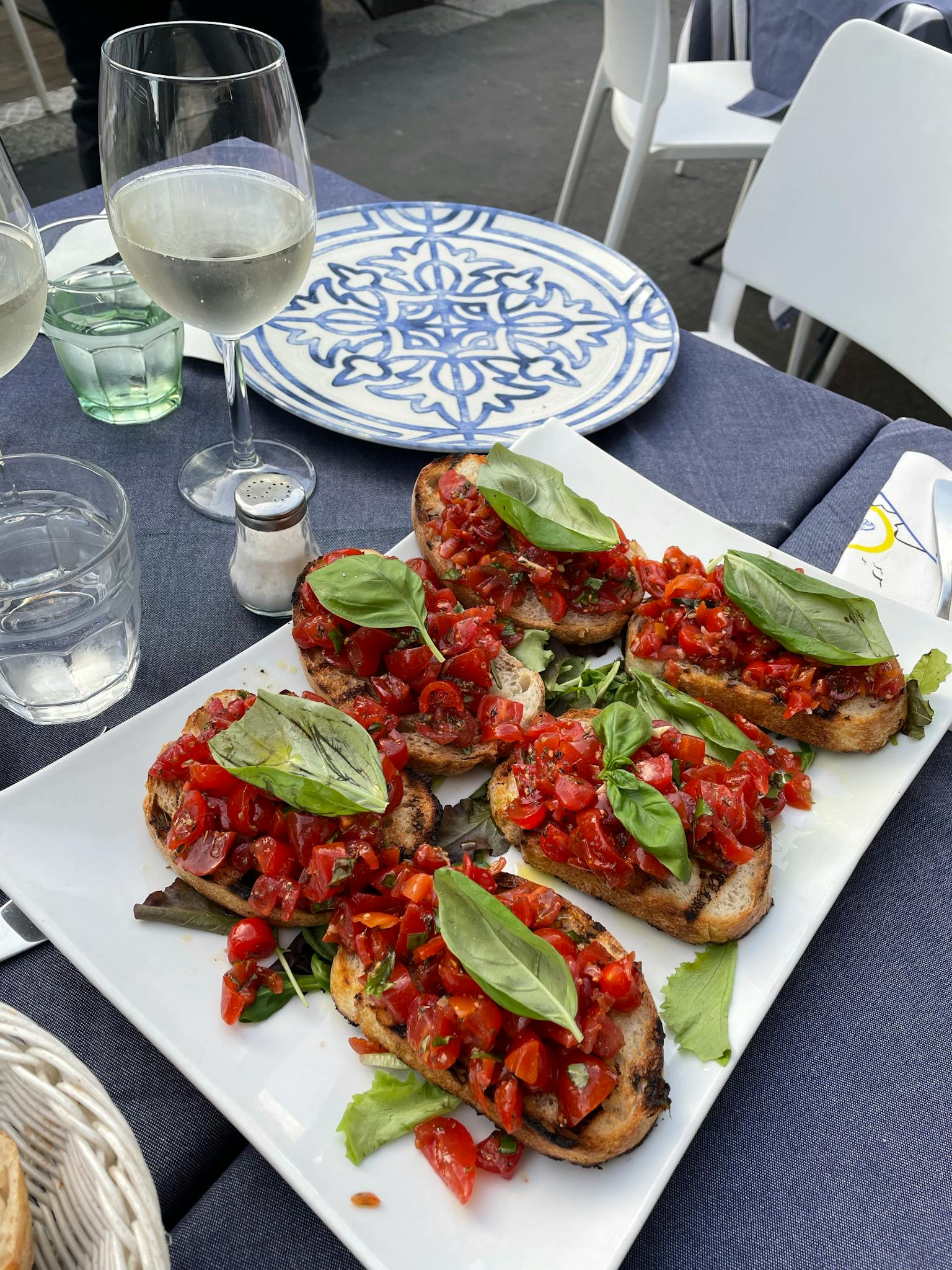 Delicious Italian bruschetta with fresh tomatoes and basil served in Milan, Italy.